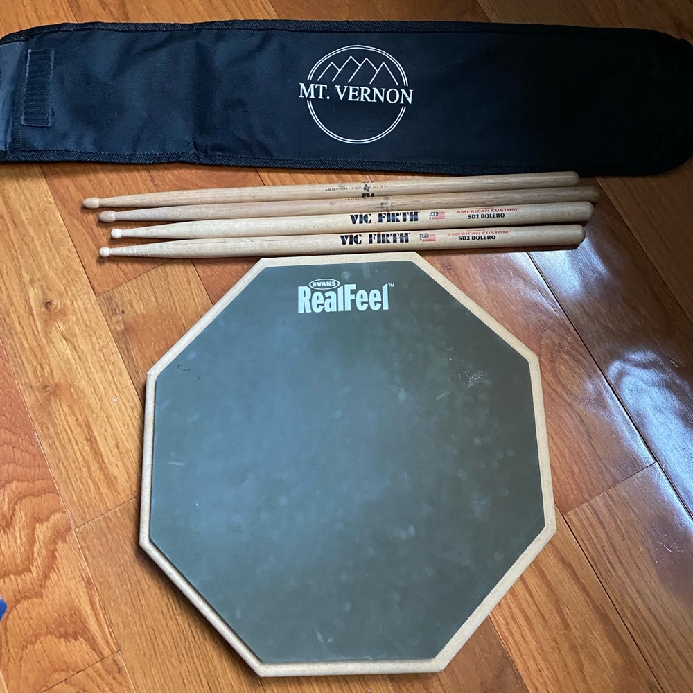 Drum practice pad and Vic Firth drum sticks.